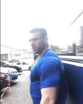Huge big bodybuilder walking in the street