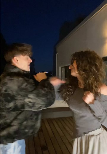 Playful Dance at Night on a Wooden Deck