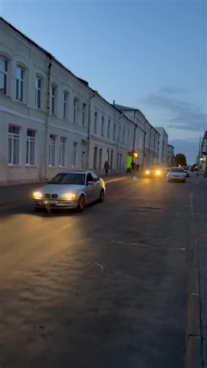 Twilight Drive: A Silver Sedan in the City