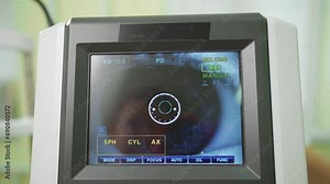 eye on the screen of the autorefractometer. a modern ophthalmic device.