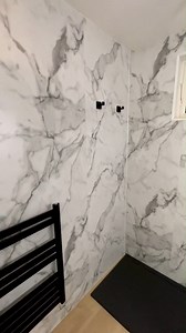 A stunning transformation by @a.mccourt_plumbing_heating, who combined our luxurious Calacatta Marble wall panel with black accessories to create a stylish and modern bathroom 🛁 Looking to achieve a similar result? Start by ordering your free sample of Calaccatta Marble on our website: https://bit.ly/3mXrXb4 📷 A McCourt Plumbing & Heating . . . #marblebathroom #marbleinterior #marbledesign | Multipanel