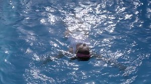 Woman inside the pool enjoying happy