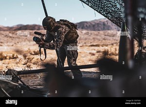U.S. Marine Corps Cpl. Iris Gantt, a Katy, Texas native, combat graphics specialist with Communication Strategy and Operations, Headquarters Battalion, Marine Air-Ground Task Force Training Command, Marine Corps Air-Ground Combat Center, records video footage during a Fire Support Coordination Exercise as part of Service Level Training Exercise 0-25 at Training Area Quackenbush, MCAGCC, Twentynine Palms, California, Dec. 6, 2024. FSCEX is a live-fire training event integrating infantry battalion