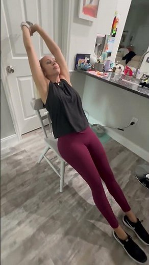 Seated full body stretch with dumbbell hold