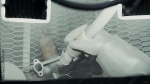 Worker cleaning and removing rust from car turbine turbocharger using a sandblasting machine, process of sandblasting metal parts