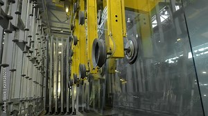 Automated manipulator with suction cups transporting glass panel at factory