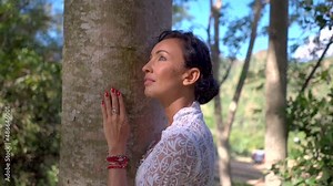 Portrait of beautiful woman hugging the tree trunk in the forest, love nature concept, connection with nature