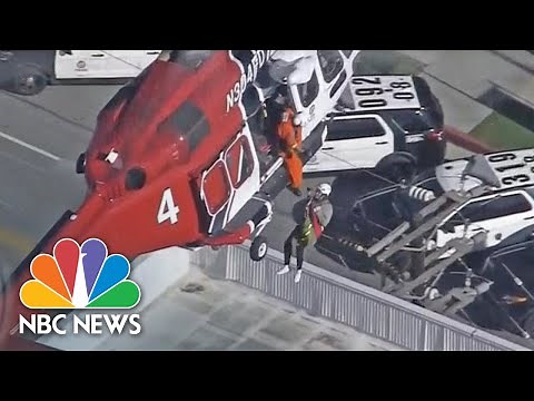 Watch Firefighters Rescue Residents From Roof Of Burning High-Rise | NBC News