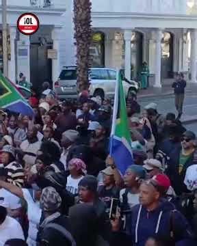 The group marches towards Western Cape Provincial Parliament as crowds merge outside