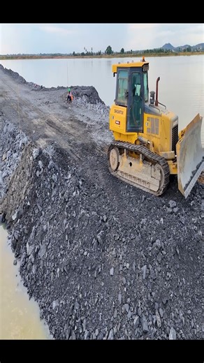 1.9K views · 35 reactions | Episode 11!Fantastic road construction project. Use trucks, a wheel loader, and a dozer Shantui to dump rocks into a sizable lake. It is truly amazing to study Project 1, which is a rapid construction of a road across a large river, with a team of experts pouring rocks into a lake, making it the site of a magnificent fish farm. | Lewis Mcinally | Facebook