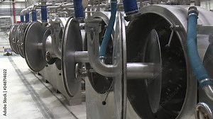 Chopping potatoes on a grater machine. Industrial workshop for the production of starch. Processing of potatoes. Production of starch
