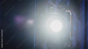 A vintage 8mm projector spins an old film reel, casting a nostalgic glow in a dark room, reminiscent of classic movie nights at home. Stock Video