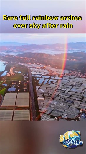 Rare full rainbow arches over sky after rain