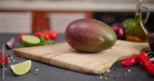 ripe mango fruit on a cutting board at the domestic kitchen