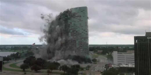 Capital One Tower comes down, leaving a large cloud of dust