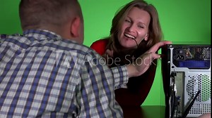 Beautiful woman flirting with technician man repairing her computer at workplace