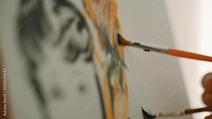 Drawing with two hands. A couple is drawing a picture. A man and woman make strokes on canvas with brushes. Rest with art. People get to know each other while drawing. A hobby that calms and relaxes