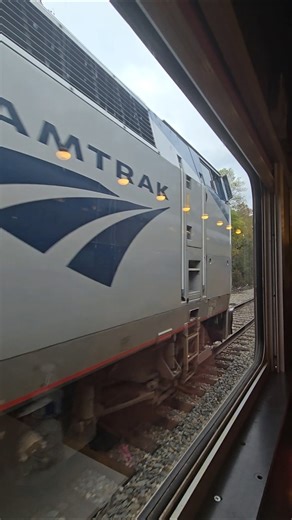 Amtrak P42 81 pulling an Amtrak passenger train past N&W 611's excursion train, 2025