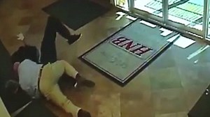 Surveillance video shows brave man tackle armed robber in bank