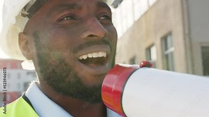 Building manager with megaphone talking, explaining and instructing construction workers, architects and engineers. Closeup headshot or infrastructure leader face motivating staff on development site