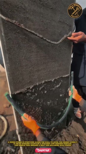 Construction workers are tidying up the wet concrete surface using a concrete leveling tool (float)