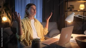 A beautiful young blonde woman is having an argument during a video conference, she gestures and expresses her dissatisfaction with the difference of opinion