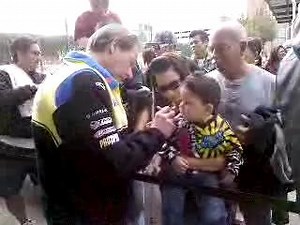 Motocross legend and Rockstar Makita Suzuki team manager Roger DeCoster signs a very young fan's jersey in Phoenix. | Suzuki | Facebook