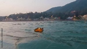 worship offerings to holy river ganges at morning from flat angle video is taken haridwar uttrakhand india on Mar 15 2022.