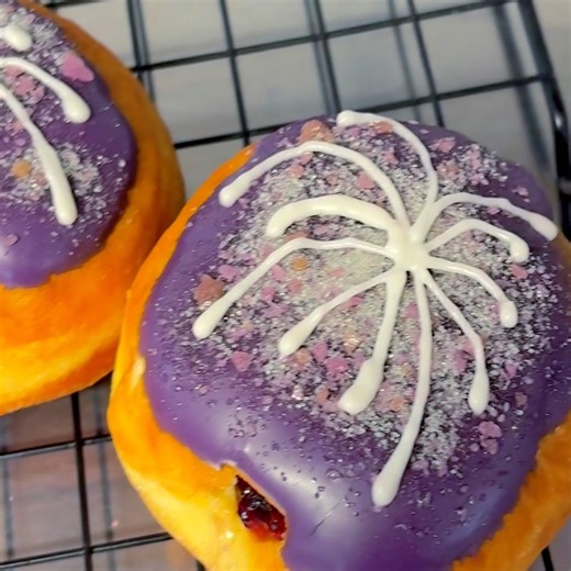 🍩🍇🎆 Grape Fireworks Jelly Filled Doughnuts! ~Fluffy yeast doughnut stuffed with grape jelly, dunked in purple vanilla icing, and then topped with grape popping candy and fireworks drizzle! . . . . #donuts #doughnuts #donutlover #donutshop #bakery #sweets #homemade #sweettooth #smallbiz #donutsofinstagram #newyearsdonuts #grape #fireworks #grapedonuts #poppingcandy #jellyfilled | Delightfluffy Doughnuts - Home-Based Bakery