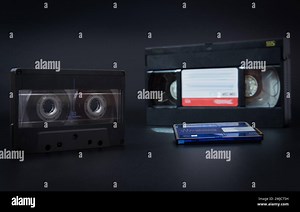 A vintage cassette tape and a VHS tape side by side on a grey background, audio cassette, video cassette, minidisc audio Stock Photo - Alamy