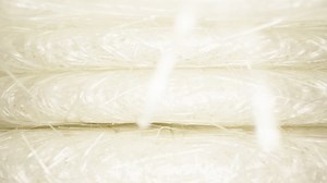 Camera flight inside, under sheets of white fiberglass. Dolly slider extreme close-up.