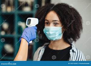Black Woman Getting Temperature Screening With Infrared Thermometer