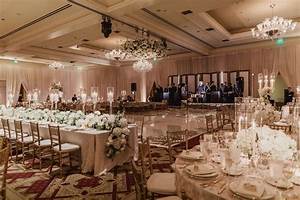 An Elegant Ballroom With Chandeliers Tables And Chairs