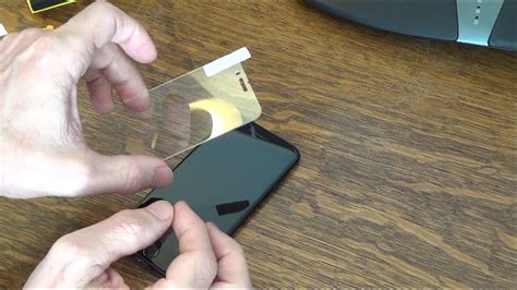 Placing tempered glass on smartphone bottom