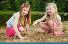 beach fun sisters playing lake summer kids sandy young having sunny warm river two children stock