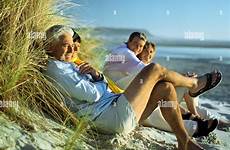 mature beach group alamy stock sitting woman