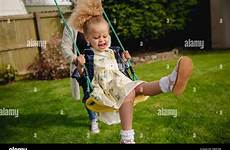 pushed swing stock girl having while being fun little her child mother alamy