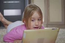 girl little playing lying computer floor tablet happy pc stock footage