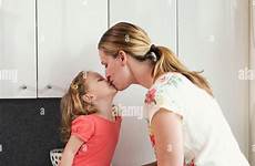 daughter kissing mother her alamy stock