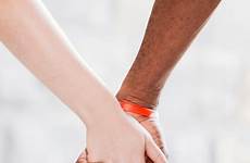 interracial holding hands couple close
