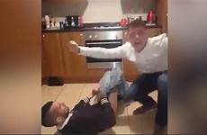 man his prank ripped trousers pants loses off floor friend he after him pull caught around trying rolls laughter ends
