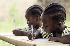 african children school students writing homework doing their holding sitting africa desk pens child essay whilst ethnicity write down blue