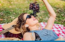 grapes eating park lying girl listening music stock while