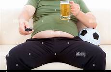 fat man sofa sitting beer drinking tv alamy