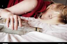 girl asleep drunk teenage alamy stock clutching drunken bottle bed woman
