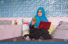 hijab networking scarf muslim laptop running computer working mobile phone head woman happy young beautiful inter
