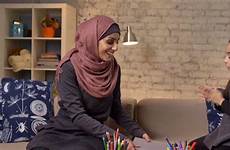 muslim mother hijab daughter her young takes hands fps laughs claps enthusiastically book