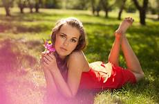 wearing girl dress park grass lying red beautiful stock young pretty