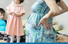 mother pregnant pregnancy third trimester birth expecting belly motherhood children woman happy baby background child stock