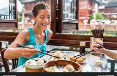 eating chinese woman restaurant xiao long food shanghai girl china dumplings travel bao xiaolongbao